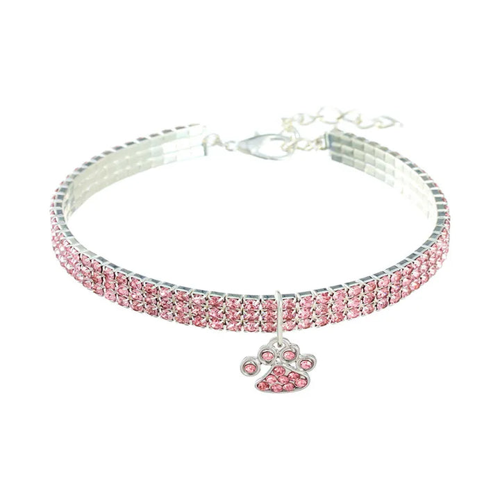 Pets-Shop. Pink rhinestone-studded pet collar with a dangling paw pendant on a white background. Shopets-Amazon.