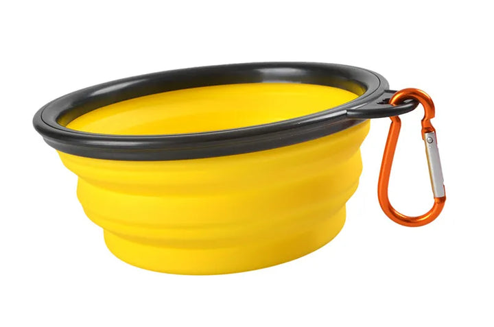 Pets-Shop. Collapsible yellow pet bowl with a black rim and an orange carabiner attached to the side. Shopets-Amazon.